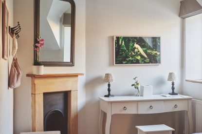 A fireplace and dressing table at Ember Cottage, Cotswolds