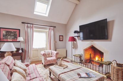 The living room with fireplace at Carroll Cottage, Cotswolds