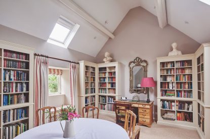 The living room with library at Carroll Cottage, Cotswolds