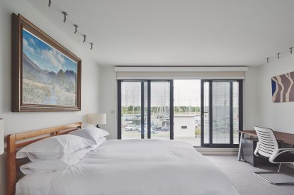 A bedroom with a balcony at The Crewhouse, Hampshire