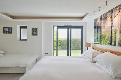 A bedroom with a balcony at The Crewhouse, Hampshire
