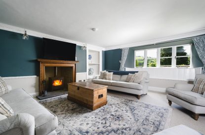 The living room with log burner at Holwell Farmhouse, Devon