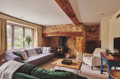 The living room with log burner at Church View Cottage, Cotswolds
