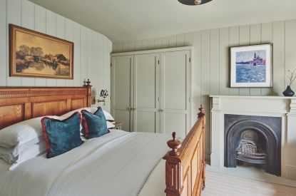 A double bedroom with fireplace at Harold House, Isle of Wight