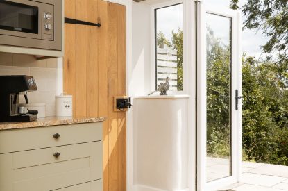 The kitchen with patio doors at Daydreamer Cottage, Cornwall
