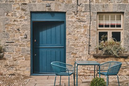 A table and two-chairs outside the entrance to Sunflower Cottage, Vale of Glamorgan