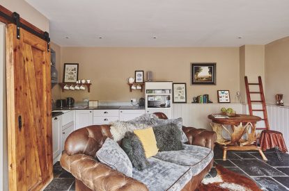 The kitchen and two-seater sofa at Mimosa Cottage, Vale of Glamorgan