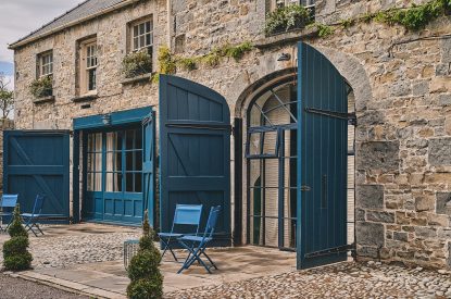 The entrance to the studio apartment and a table and chairs at Muscari Cottage, Vale of Glamorgan