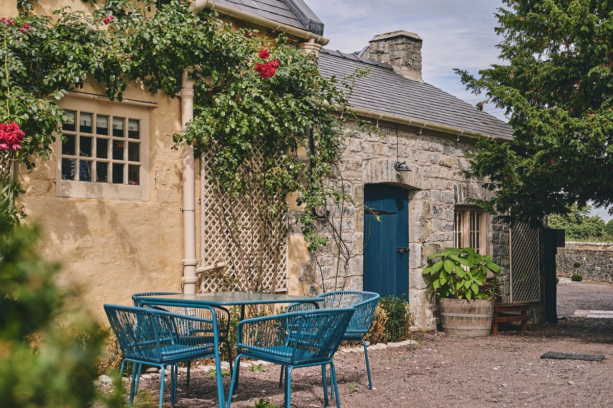 The exterior of the cottage and a shared seating area at Fritillaria Cottage, Vale of Glamorgan