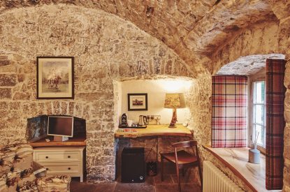 The desk area and exposed brick walls at Fritillaria Cottage, Vale of Glamorgan