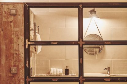 A view into the en-suite from the king-size bedroom at Fritillaria Cottage, Vale of Glamorgan