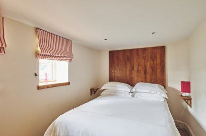 A king-size bedroom at Lotus Cottage, Vale of Glamorgan