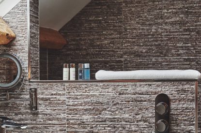 The shower and luxury toiletries in the bathroom at Hollyhock Cottage, Vale of Glamorgan