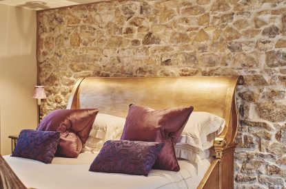 The soft furnishings on the king-size bed at Hollyhock Cottage, Vale of Glamorgan