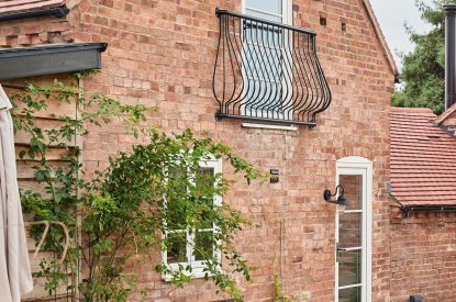 The exterior of the cottage with a Juliet balcony at Hay Bale Cottage, Worcestershire
