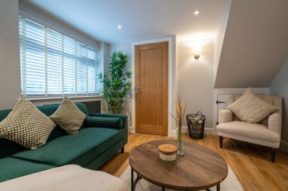 The two-seater sofa and single armchair in the living room at Pilgrim Cottage, Cheshire