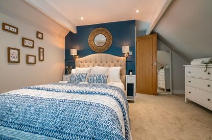 The master bedroom with a double bed at Pilgrim Cottage, Cheshire