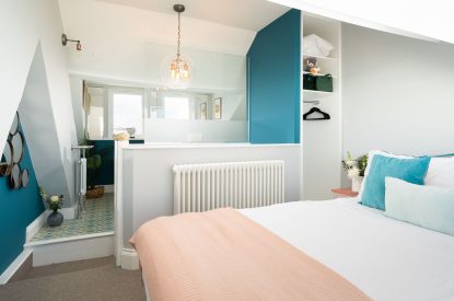 The master bedroom with an en-suite bathroom at Waters Dream, Devon