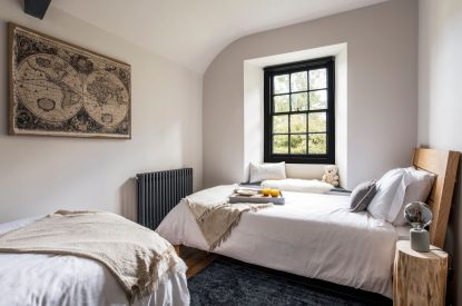 A twin bedroom at Padstone Farmhouse, Cornwall