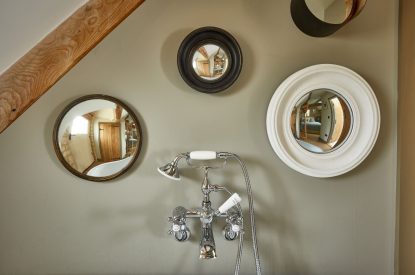 Mirrors on the wall in the bathroom at Orchard Stable, Cotswolds