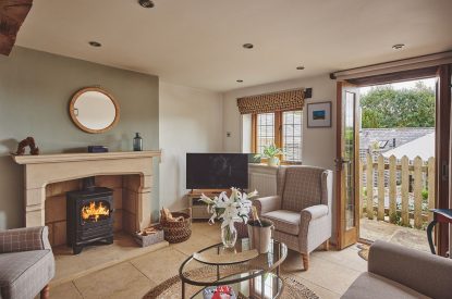 The living room with log burner at Acorn Barn, Cotswolds