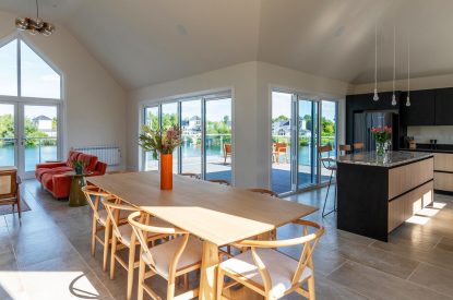 The dining room and kitchen at Lakefront Lodge, Cotswolds
