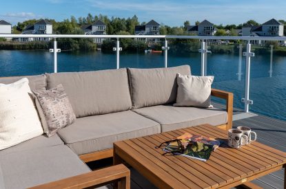 A sitting area on the balcony at Lakefront Lodge, Cotswolds