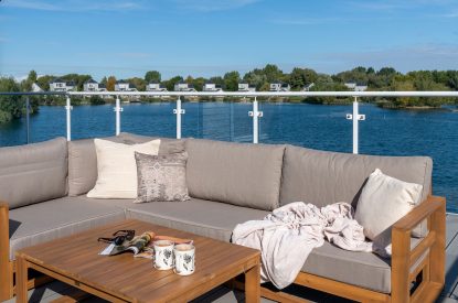 A sitting area on the balcony at Lakefront Lodge, Cotswolds