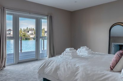 A double bedroom with lake view at Lakefront Lodge, Cotswolds