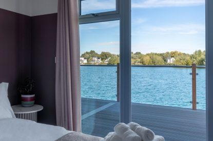 A double bedroom with lake view at Lakefront Lodge, Cotswolds