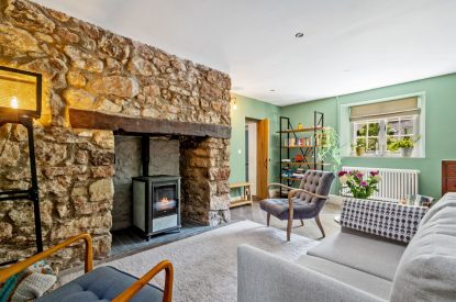 The living room with log burner at Teacher's Cottage, Gower