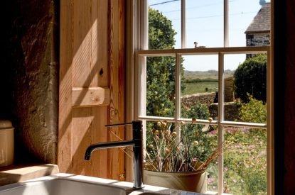 A sink in front of the window overlooking the countryside at Chapel Cottage, Pembrokeshire