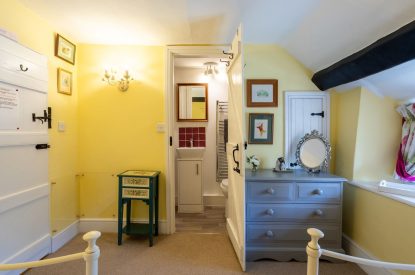 A twin bedroom with beams at Sweet Shop Cottage, Somerset