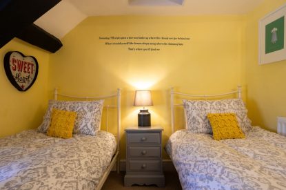 A twin bedroom with beams at Sweet Shop Cottage, Somerset