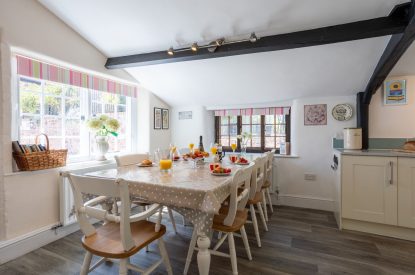 The dining table with view onto the garden at Sweet Shop Cottage, Somerset