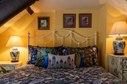 A double bedroom with beams at Thatch Corner, Somerset