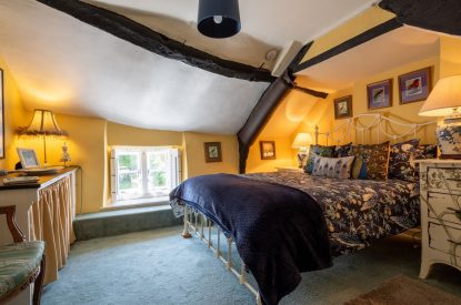 A double bedroom with beams at Thatch Corner, Somerset