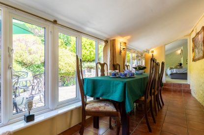 A garden room with a formal dining table at Thatch Corner, Somerset