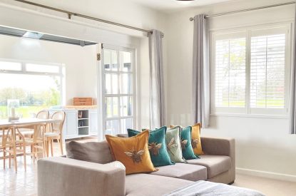 The living room leading to the dining table at Brickworks and Vines, Isle of Wight