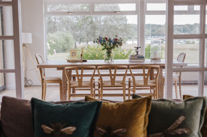 The living room leading to the dining table at Brickworks and Vines, Isle of Wight