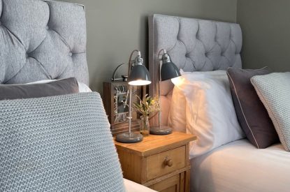 A bedroom with twin beds at Brickworks and Vines, Isle of Wight