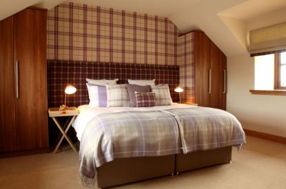 A super king size bedroom at The Clans, Fife
