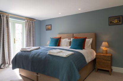 A super king sized bedroom at Poppy Cottage, Somerset