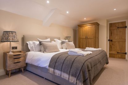 A super king sized bedroom at The Thatched Cottage, Somerset