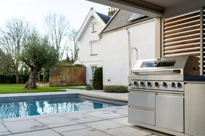 The outdoor kitchen and swimming pool at White Exeter House, Devon