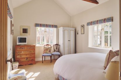 A super king sized bedroom at Hockham Pool House, Norfolk Coast