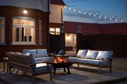 The fire pit at night at Merry Manor, Essex