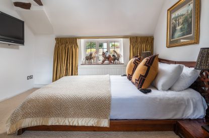A king sized bedroom at The Old Post Office, Cotswolds