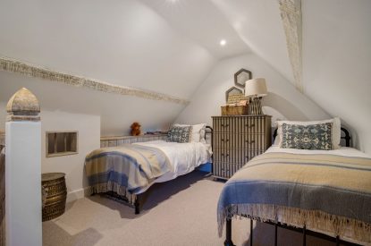 A twin bedroom at The Priory Gatehouses, Essex