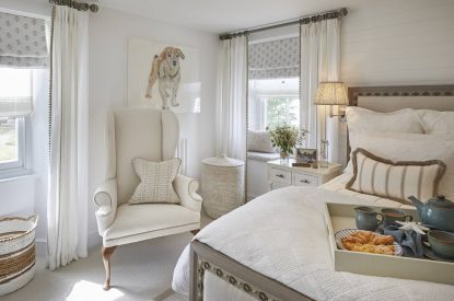 A bedroom with an armchair at The Beach House, Devon